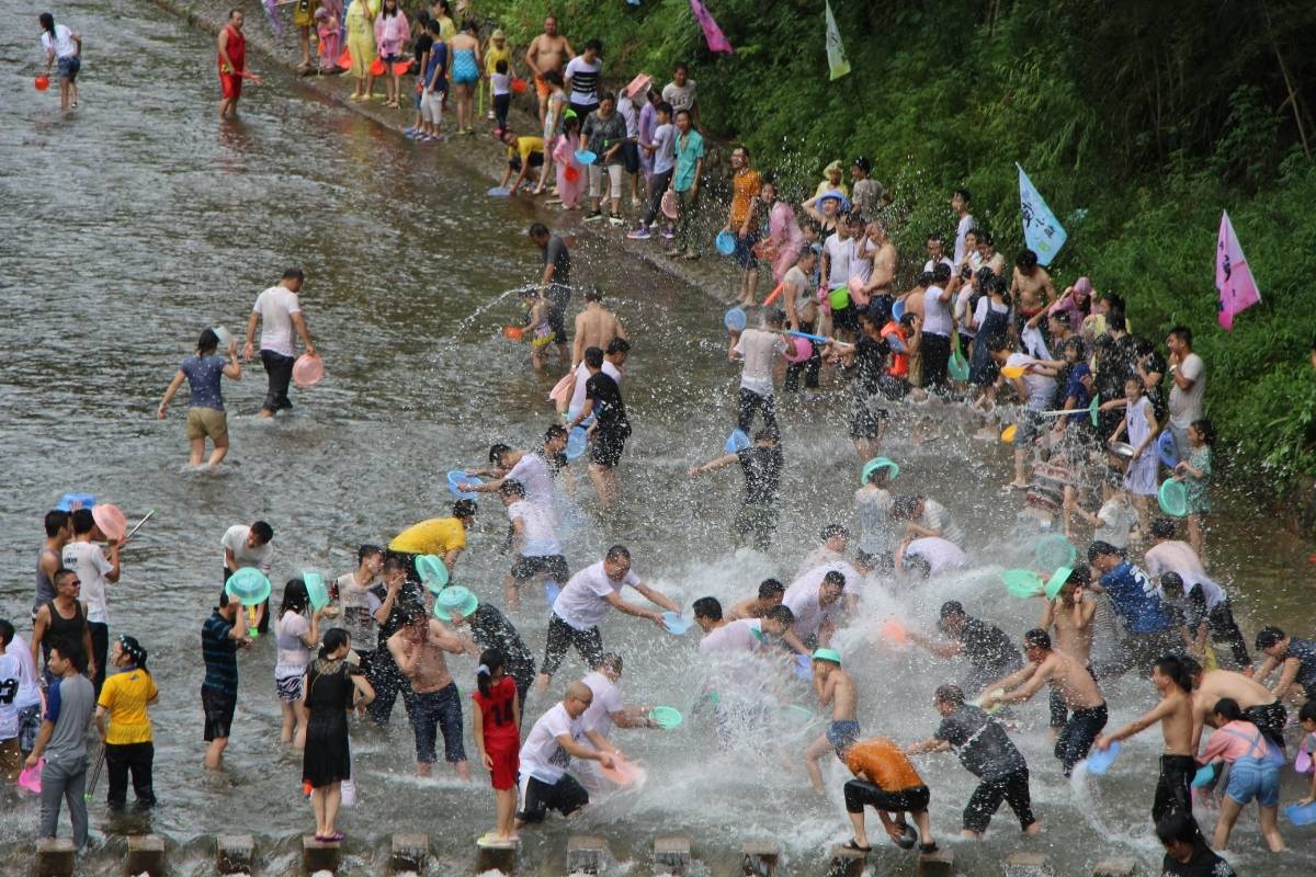 people splashing water together in songkran phuket festival
